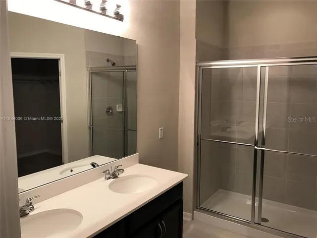 a bathroom with a sink and mirror