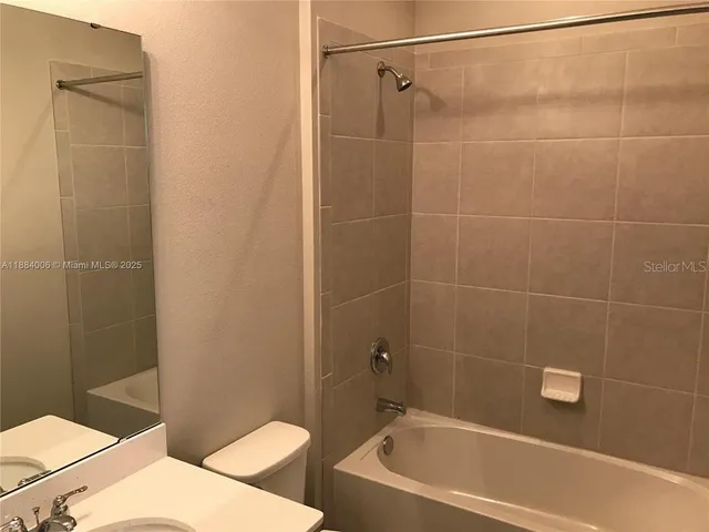 a bathroom with a toilet and shower