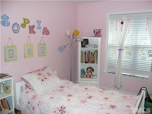 4415 Pike Road Raleigh, NC 27613 - Photo 11 of 19 a bedroom with a bed and a dresser in it