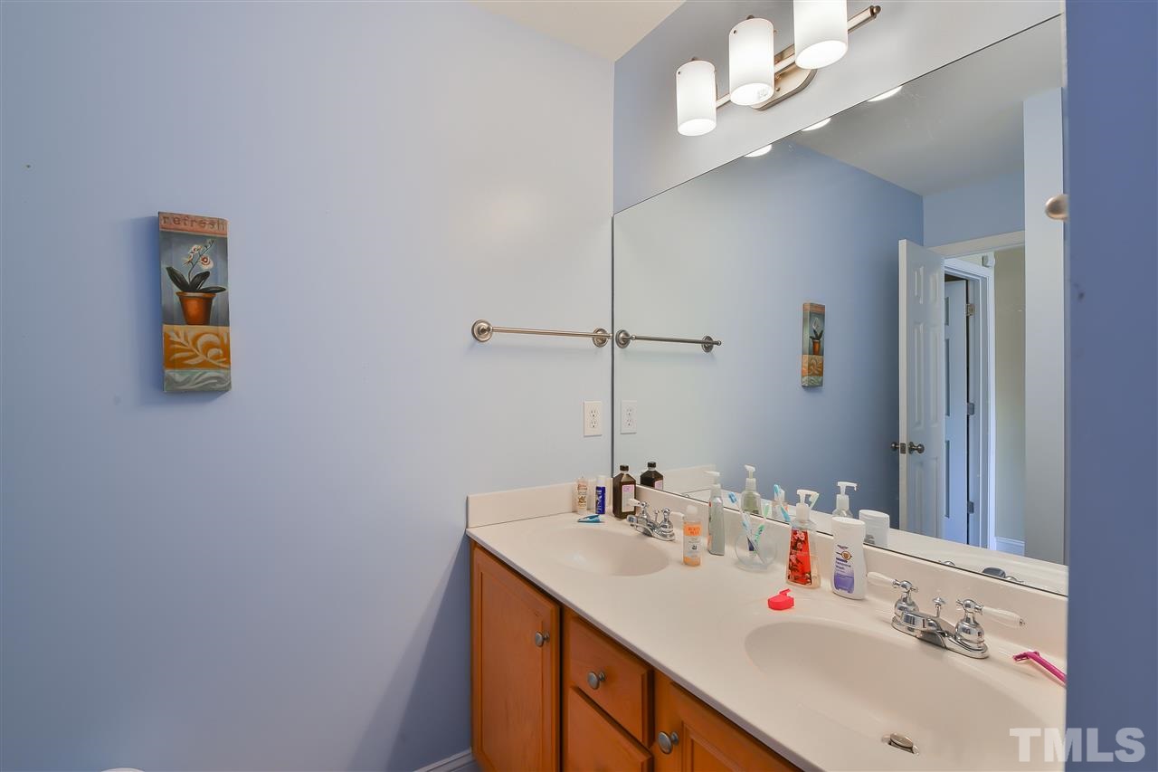 4415 Pike Road Raleigh, NC 27613 - Photo 12 of 19 a bathroom with a sink and a mirror