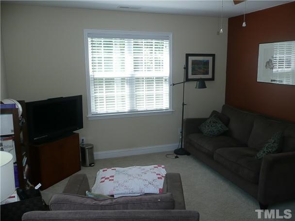 4415 Pike Road Raleigh, NC 27613 - Photo 14 of 19 a living room with furniture and a flat screen tv
