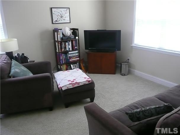 4415 Pike Road Raleigh, NC 27613 - Photo 15 of 19 a living room with furniture and a flat screen tv
