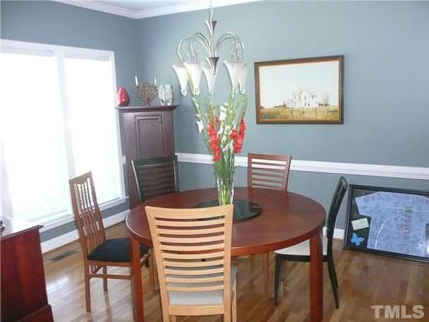 4415 Pike Road Raleigh, NC 27613 - Photo 3 of 19 a view of a dining room with furniture and wooden floor