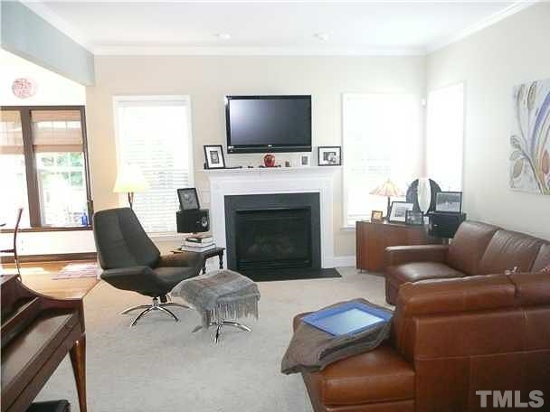 4415 Pike Road Raleigh, NC 27613 - Photo 7 of 19 a living room with furniture a fireplace and a flat screen tv