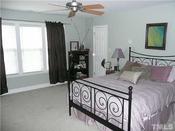 4415 Pike Road Raleigh, NC 27613 - Photo 8 of 19 a bedroom with a bed and a window