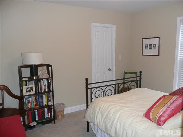 4415 Pike Road Raleigh, NC 27613 - Photo 10 of 19 a bedroom with a bed and a book shelf