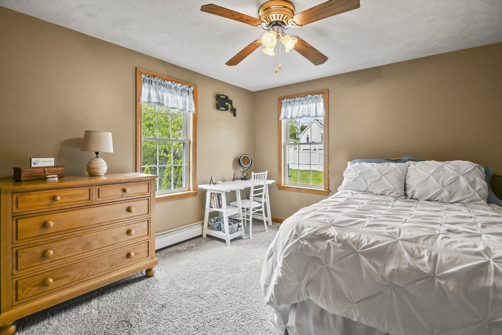 18 Jackson Avenue Rutland, MA 01543 - Photo 12 of 24 a bedroom with a bed and a chandelier