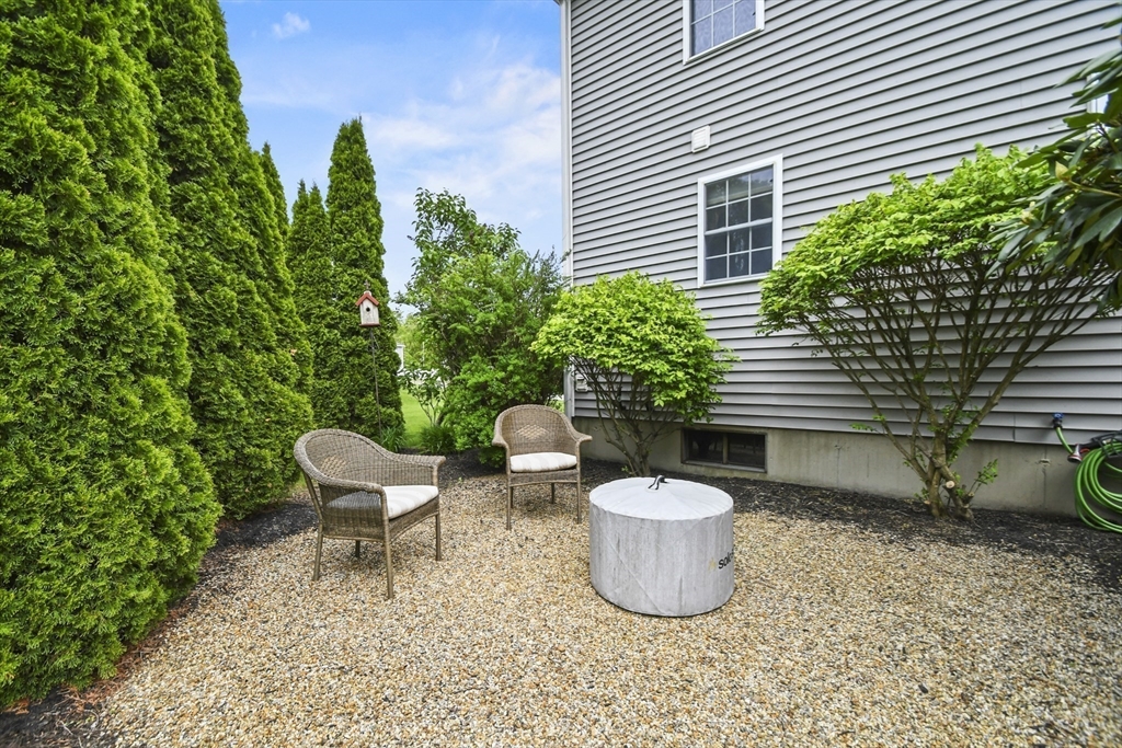 18 Jackson Avenue Rutland, MA 01543 - Photo 15 of 24 a view of a backyard with plants and chairs
