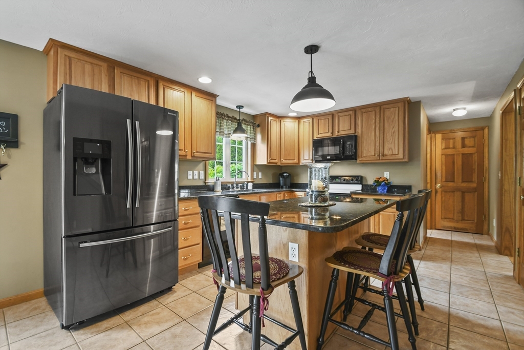 18 Jackson Avenue Rutland, MA 01543 - Photo 2 of 24 a kitchen with stainless steel appliances granite countertop a refrigerator a stove a sink a microwave and island