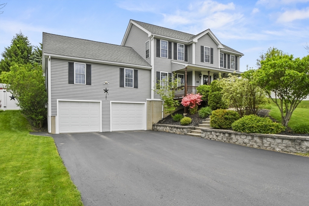 18 Jackson Avenue Rutland, MA 01543 - Photo 21 of 24 a front view of a house with a yard and a garden
