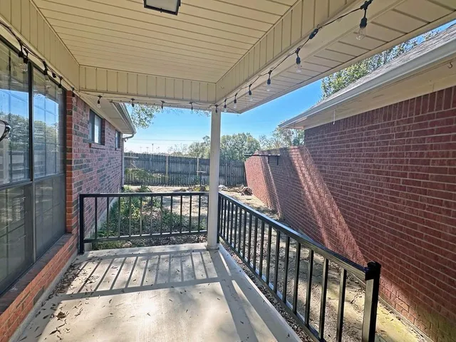a view of balcony with wooden floor