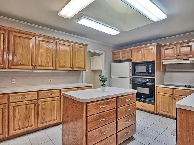 a kitchen with stainless steel appliances granite countertop a refrigerator and cabinets