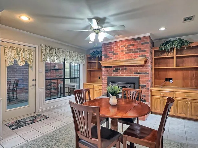 a dining room with furniture a chandelier and window