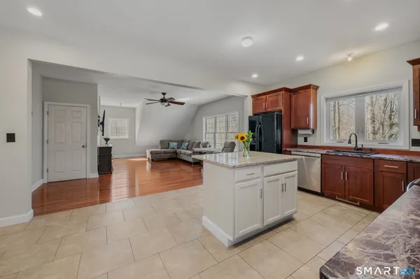 a kitchen with stainless steel appliances granite countertop a stove and a sink