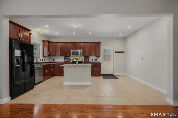 a kitchen with a refrigerator and a sink