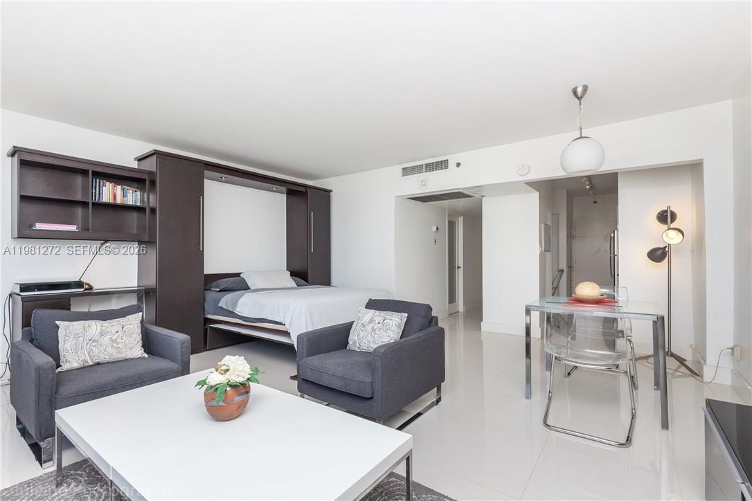 100 Lincoln Road, Unit 806 Miami Beach, FL 33139 - Photo 11 of 23 a living room with furniture and wooden floor