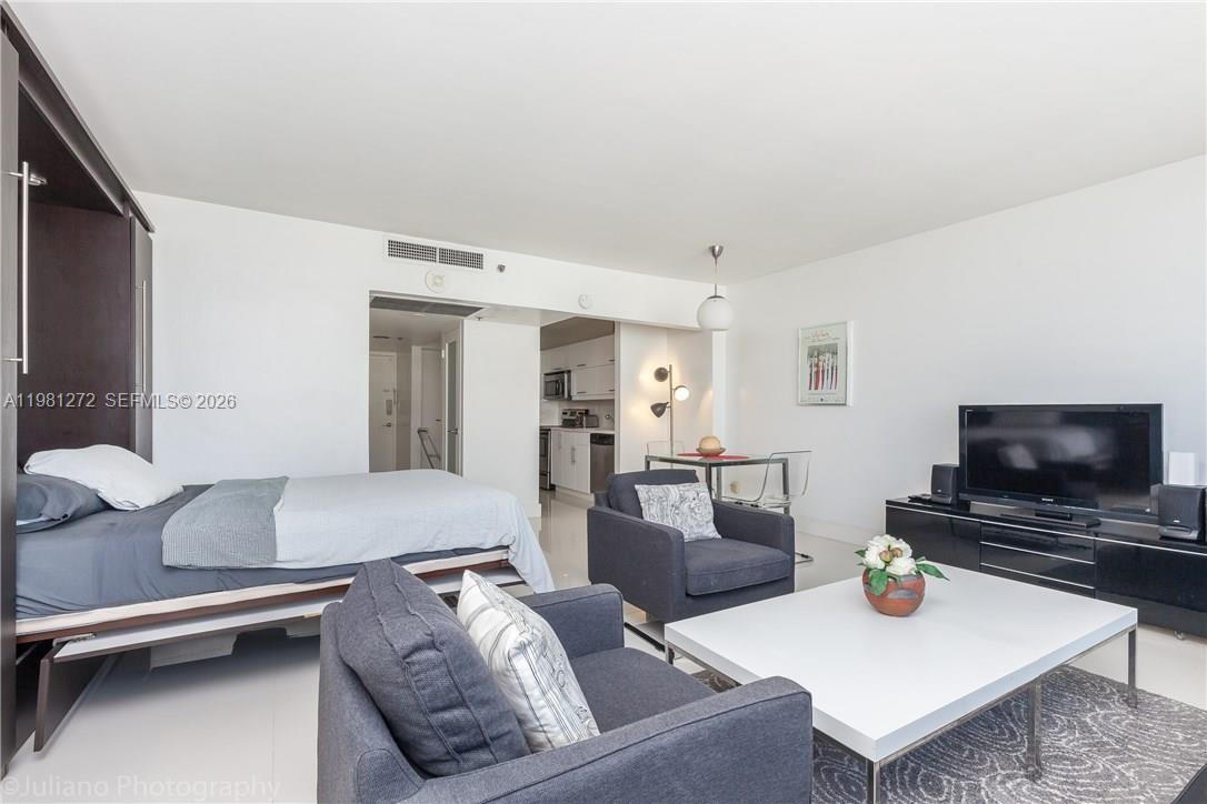 100 Lincoln Road, Unit 806 Miami Beach, FL 33139 - Photo 13 of 23 a living room with furniture and a flat screen tv