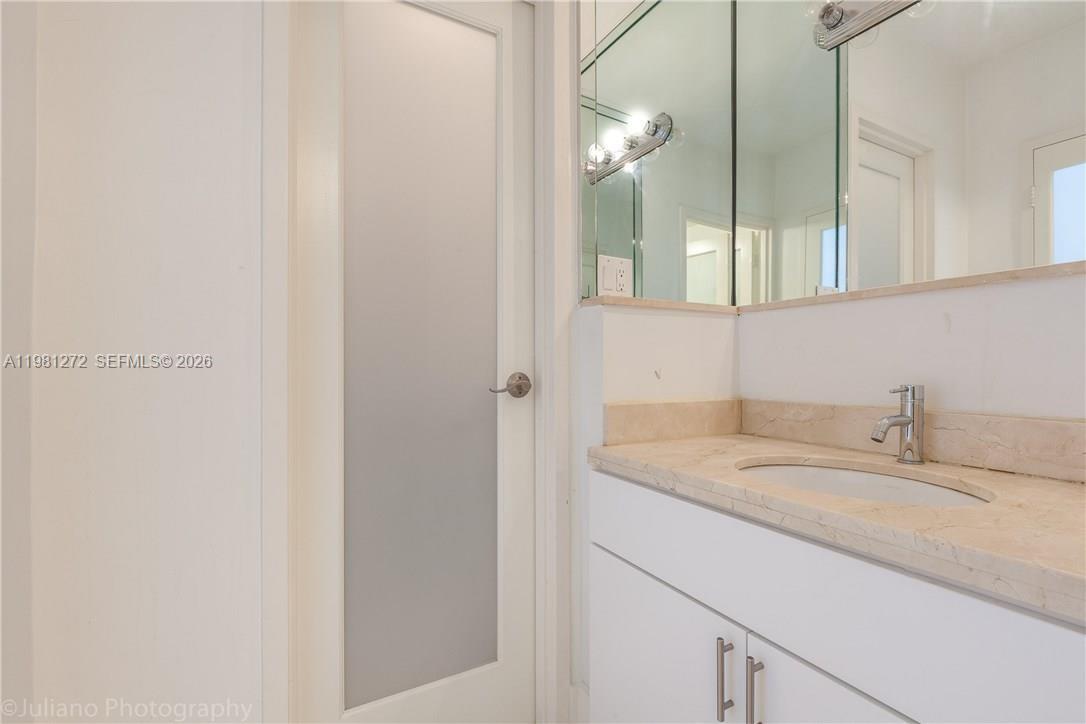 100 Lincoln Road, Unit 806 Miami Beach, FL 33139 - Photo 16 of 23 a bathroom with a granite countertop sink and a mirror