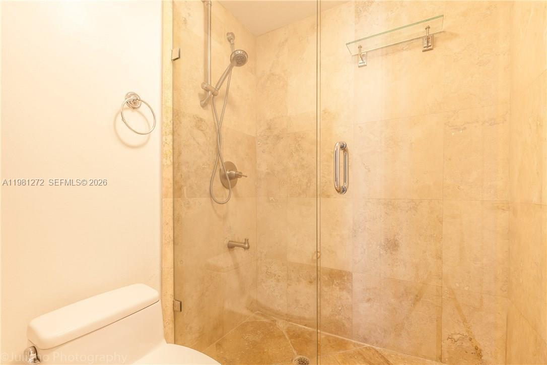 100 Lincoln Road, Unit 806 Miami Beach, FL 33139 - Photo 17 of 23 a bathroom with a shower curtain and a toilet