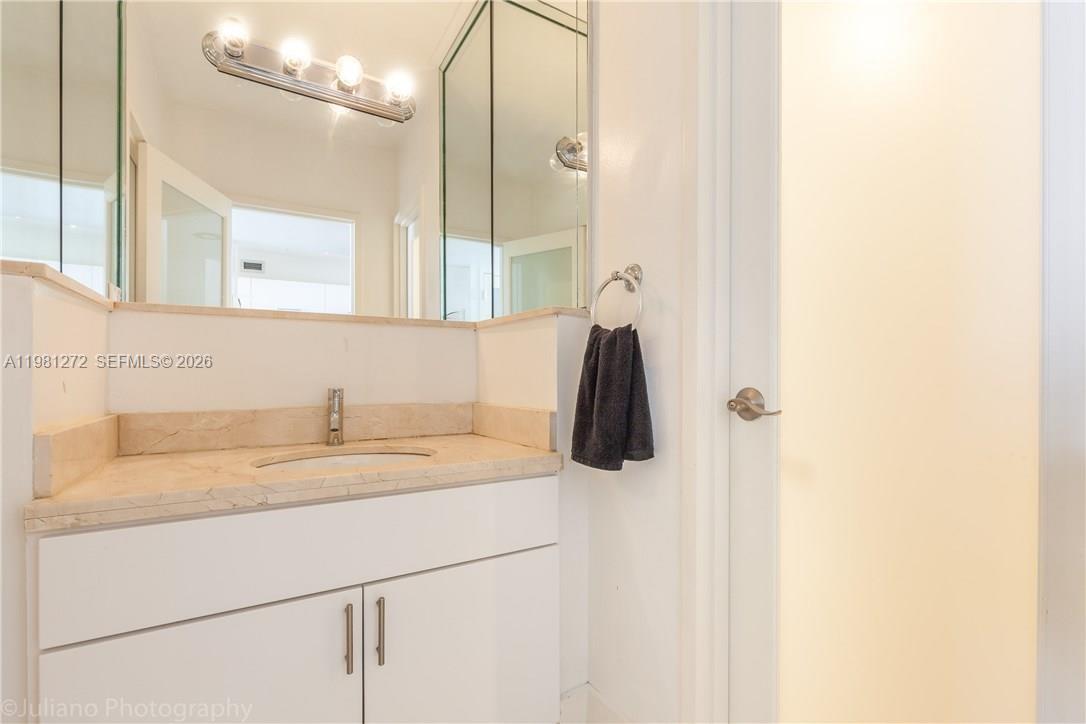 100 Lincoln Road, Unit 806 Miami Beach, FL 33139 - Photo 18 of 23 a bathroom with a sink and a mirror