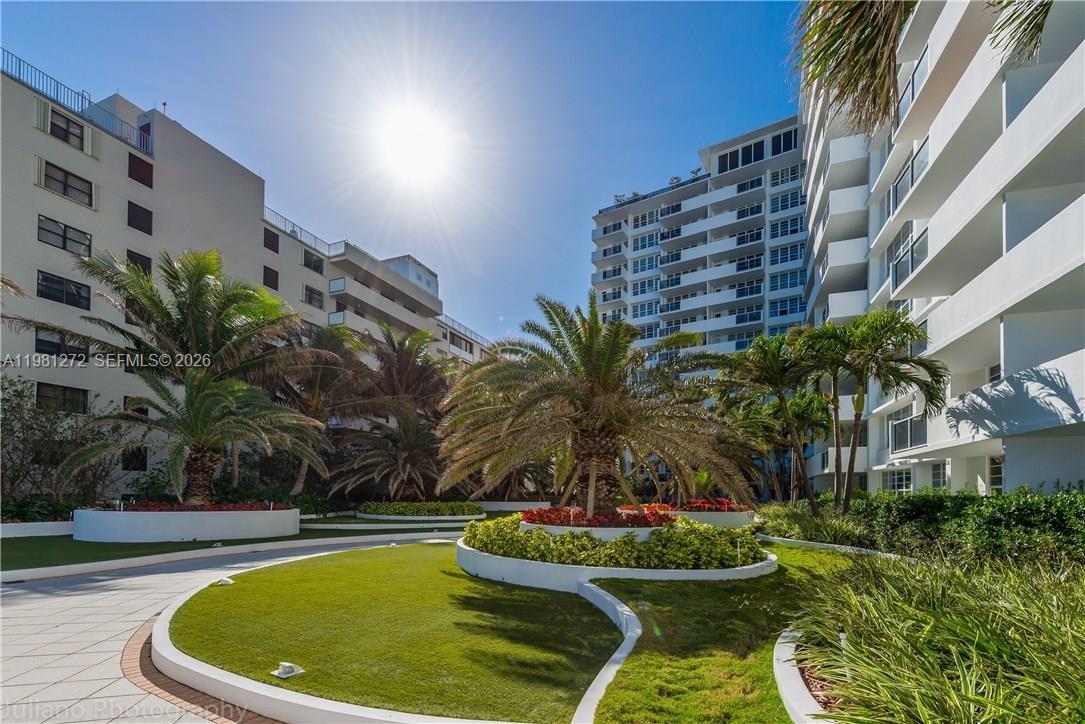 100 Lincoln Road, Unit 806 Miami Beach, FL 33139 - Photo 21 of 23 a view of a swimming pool with a lawn chairs and plants