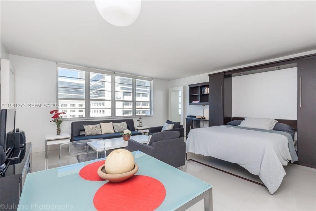 100 Lincoln Road, Unit 806 Miami Beach, FL 33139 - Photo 3 of 23 a bedroom with a bed and a large window