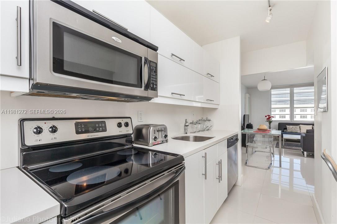 100 Lincoln Road, Unit 806 Miami Beach, FL 33139 - Photo 4 of 23 a kitchen with a stove and a microwave