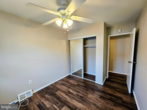 wooden floor in an empty room with a mirror