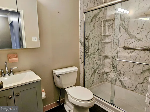 a bathroom with a toilet sink and shower
