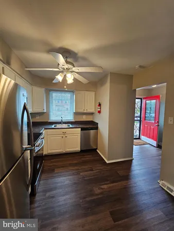 a kitchen with stainless steel appliances granite countertop a refrigerator a stove and a sink