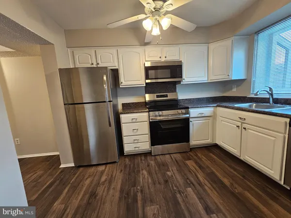 a kitchen with a white cabinets and white appliances