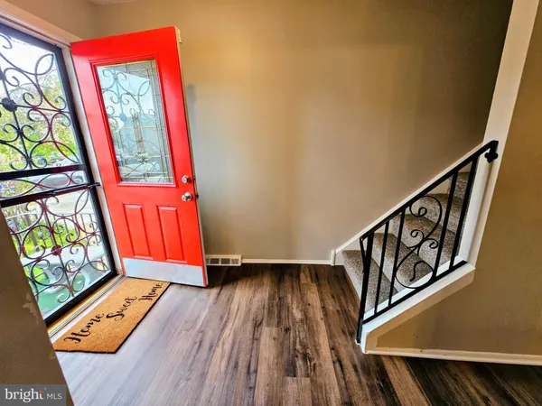 a view of an entryway with wooden floor