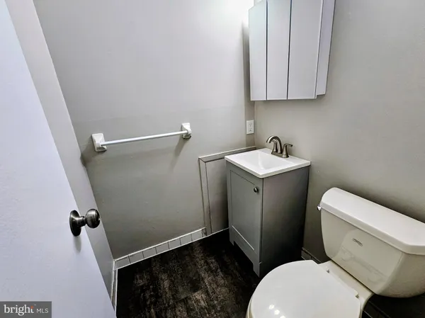 a white toilet sitting next to a bathroom sink