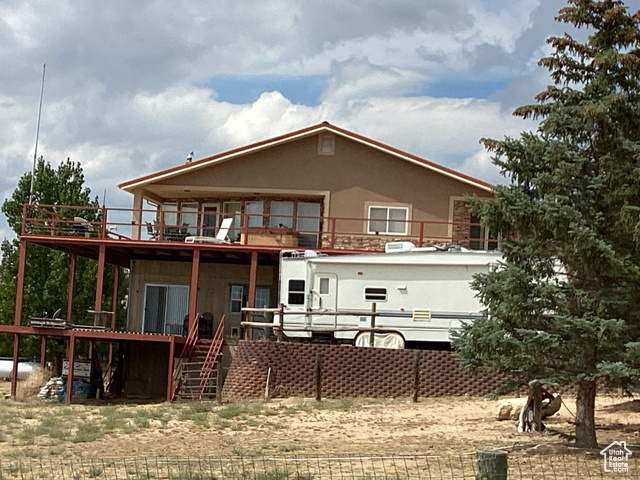 3 Red Circle, Unit 19 Manila, UT 84046 - Photo 2 of 29 Back of property featuring a balcony, stairway, and a deck