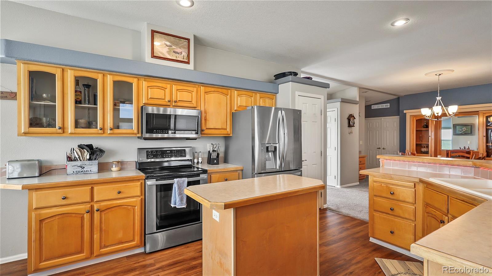 48984 County Road Akron, CO 80720 - Photo 11 of 35 a kitchen with stainless steel appliances granite countertop a stove refrigerator sink and cabinets