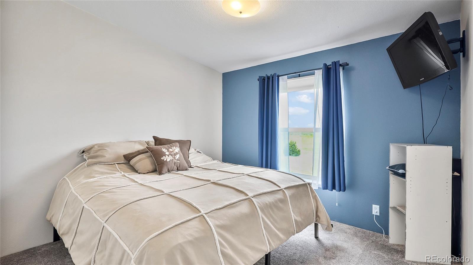 48984 County Road Akron, CO 80720 - Photo 21 of 35 a bedroom with a bed and a television