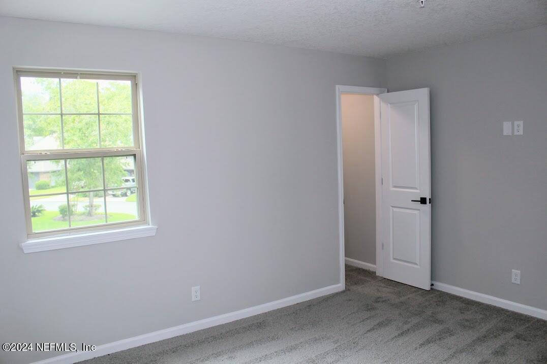 4146 Quiet Creek Loop, Unit 131 Middleburg, FL 32068 - Photo 16 of 39 an empty room with windows