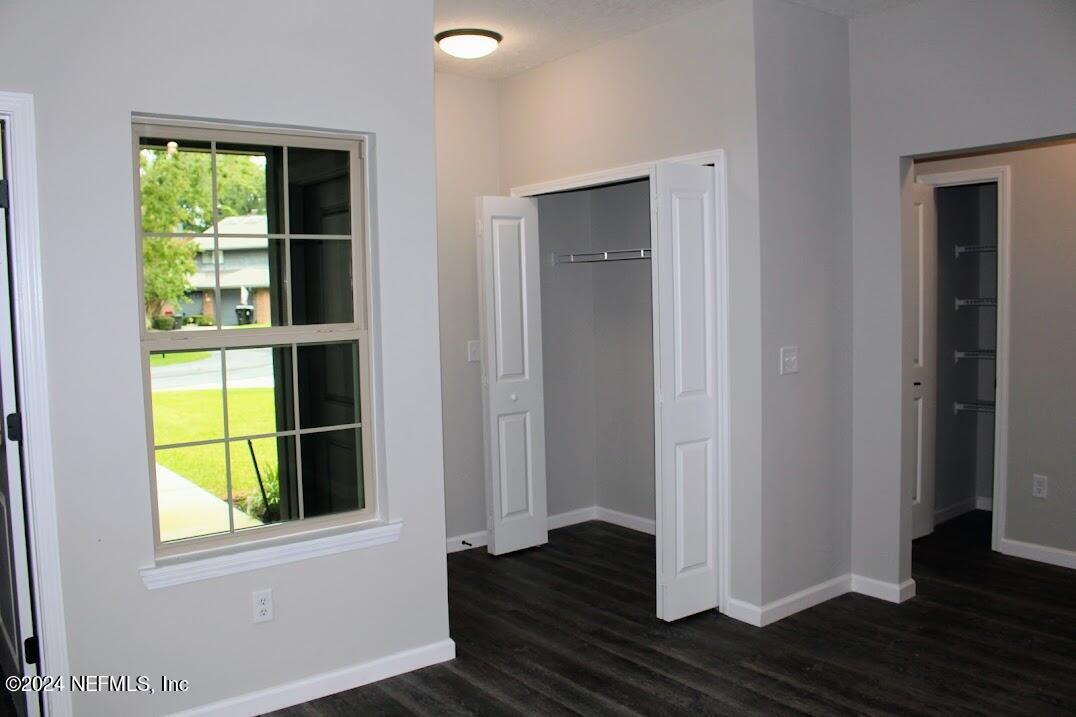 4146 Quiet Creek Loop, Unit 131 Middleburg, FL 32068 - Photo 2 of 39 an empty room with wooden floor closet and windows
