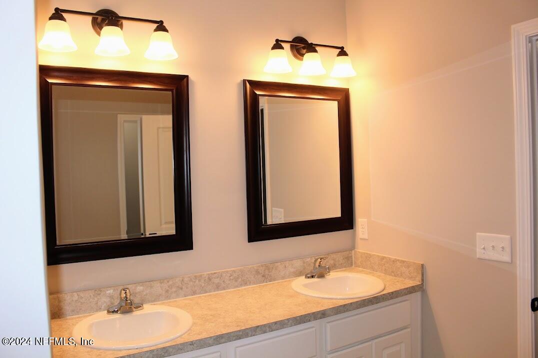 4146 Quiet Creek Loop, Unit 131 Middleburg, FL 32068 - Photo 21 of 39 a bathroom with mirror a sink and a mirror