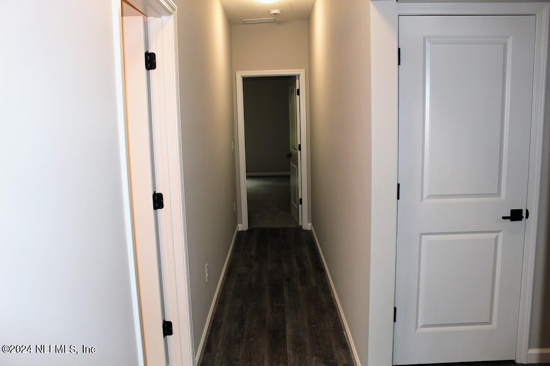 4146 Quiet Creek Loop, Unit 131 Middleburg, FL 32068 - Photo 28 of 39 a view of a hallway with a wooden door
