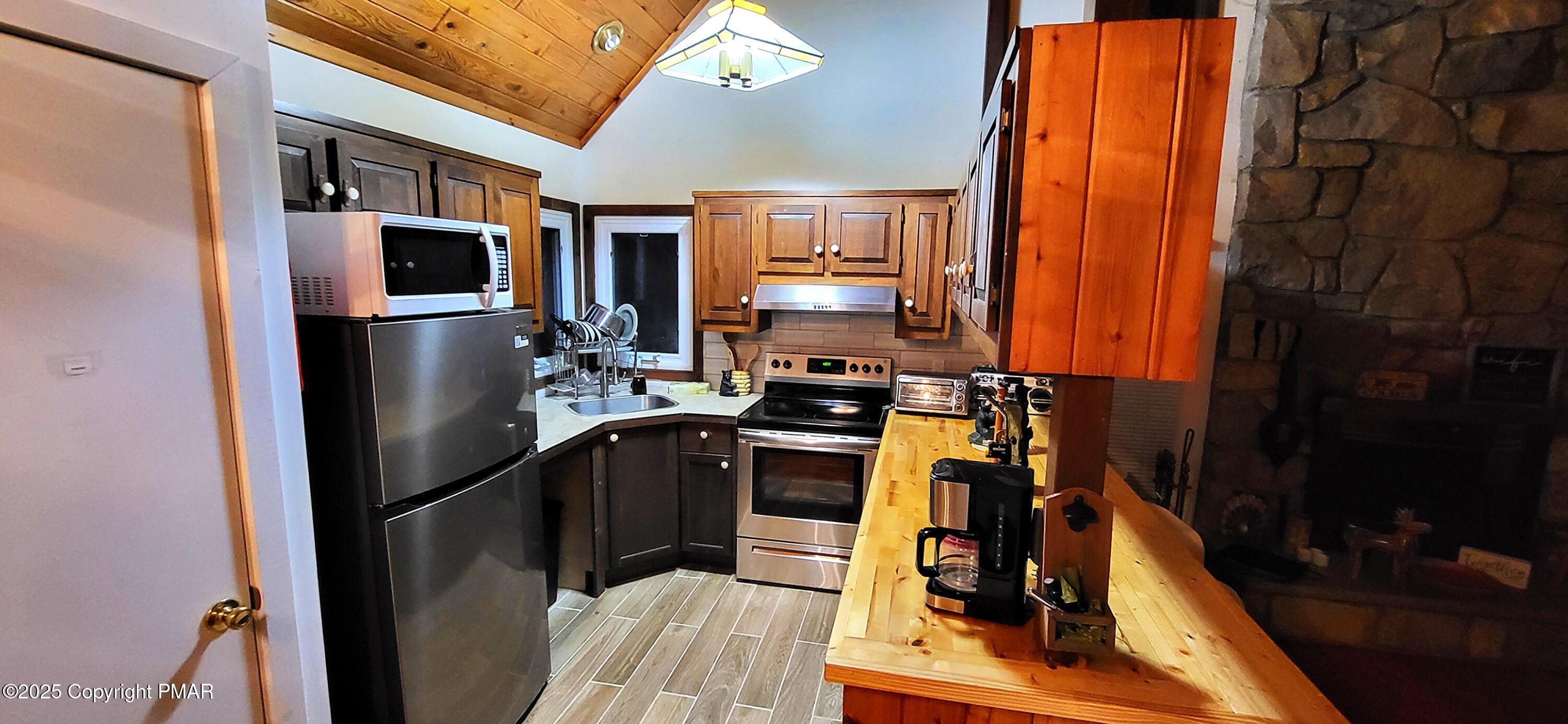 6298 Decker Road Bushkill, PA 18324 - Photo 15 of 65 a kitchen with stainless steel appliances granite countertop a refrigerator a stove top oven a sink and dishwasher
