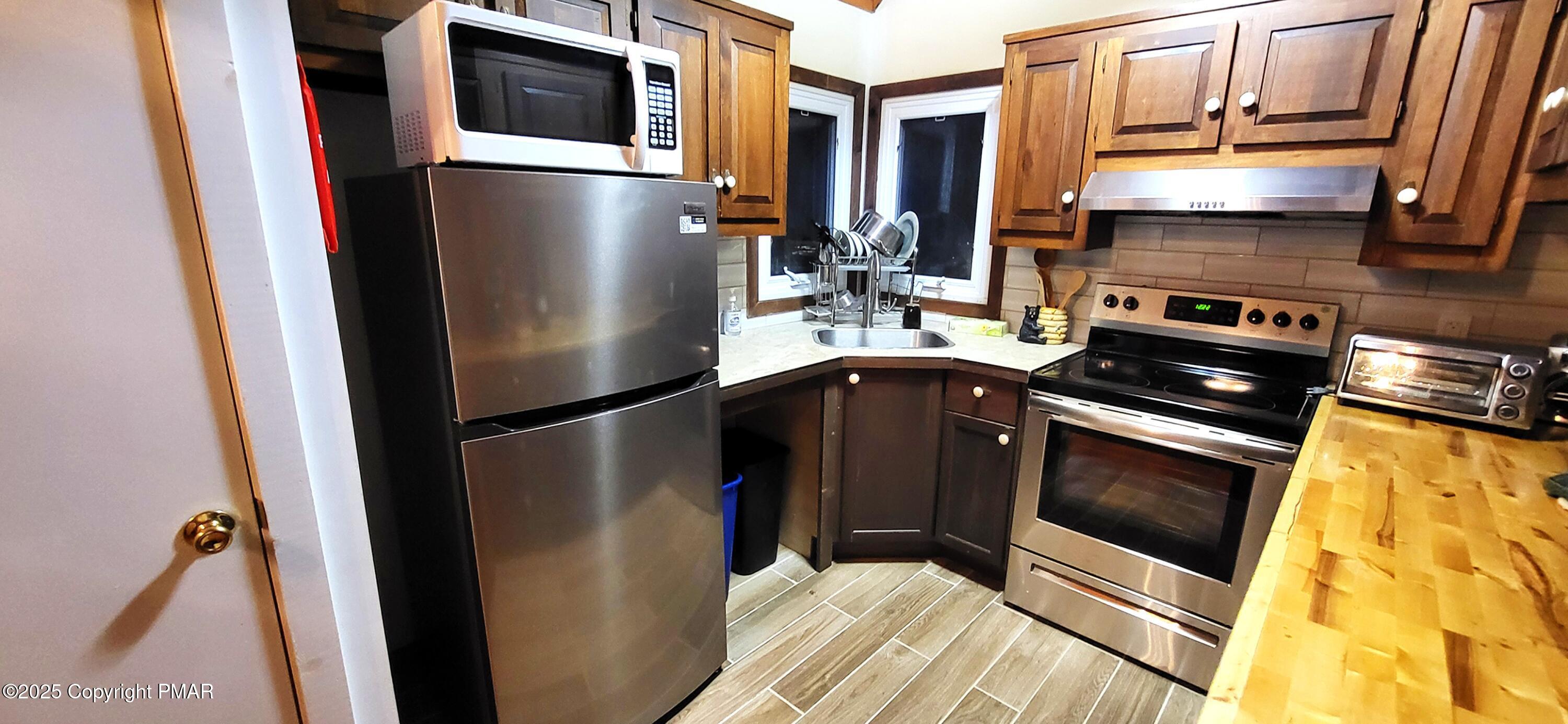 6298 Decker Road Bushkill, PA 18324 - Photo 16 of 65 a metallic refrigerator freezer sitting inside of a kitchen