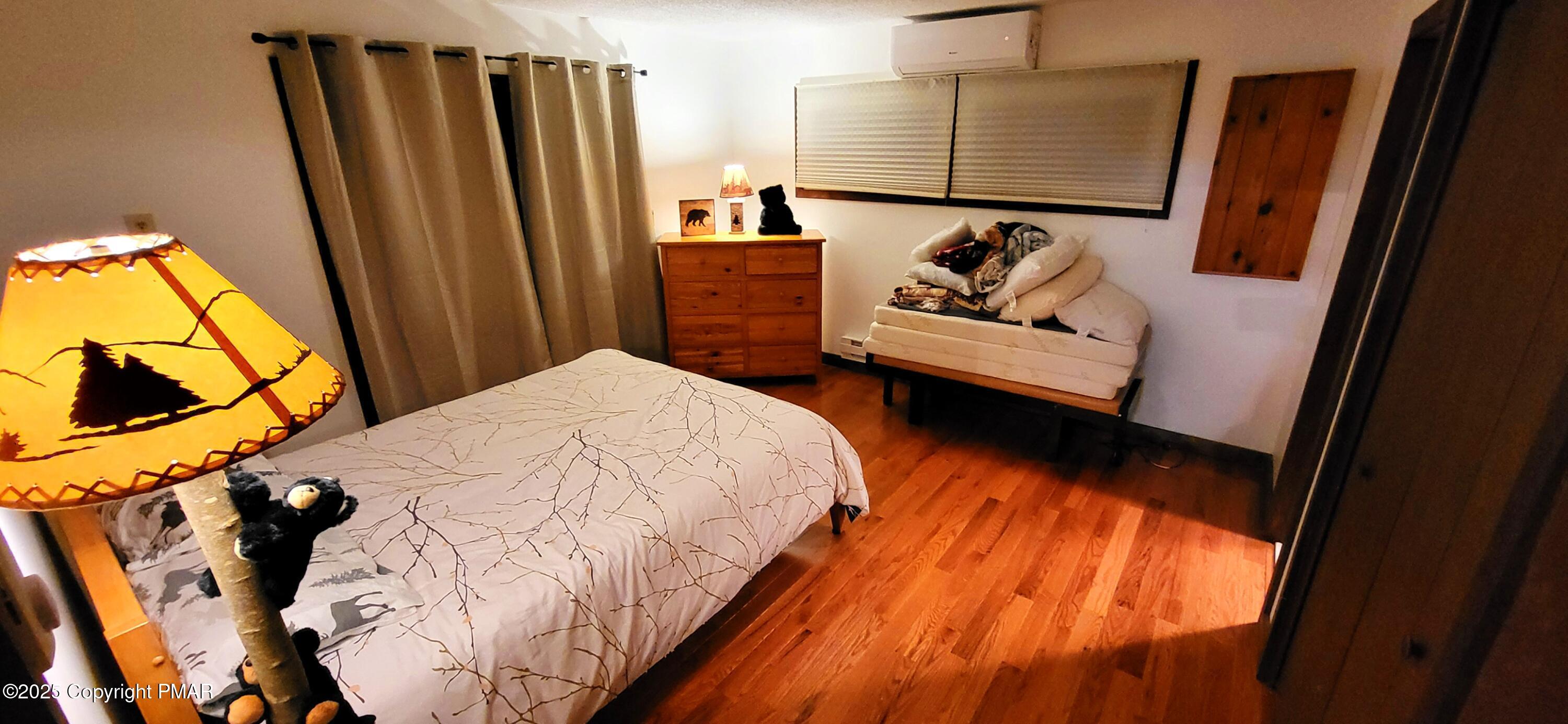 6298 Decker Road Bushkill, PA 18324 - Photo 19 of 65 a bedroom with a bed and a flat tv screen on the dresser