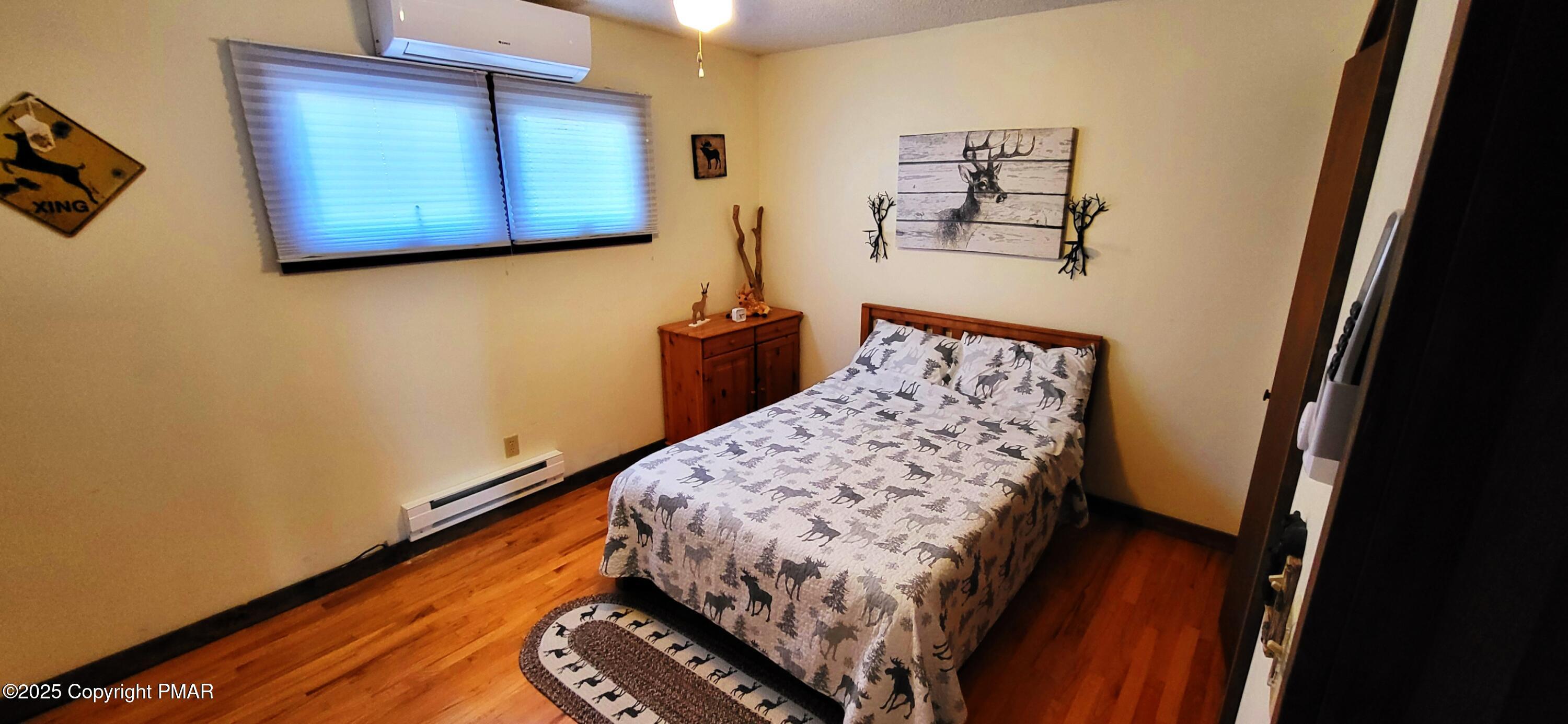 6298 Decker Road Bushkill, PA 18324 - Photo 23 of 65 a bedroom with a bed and wooden floor