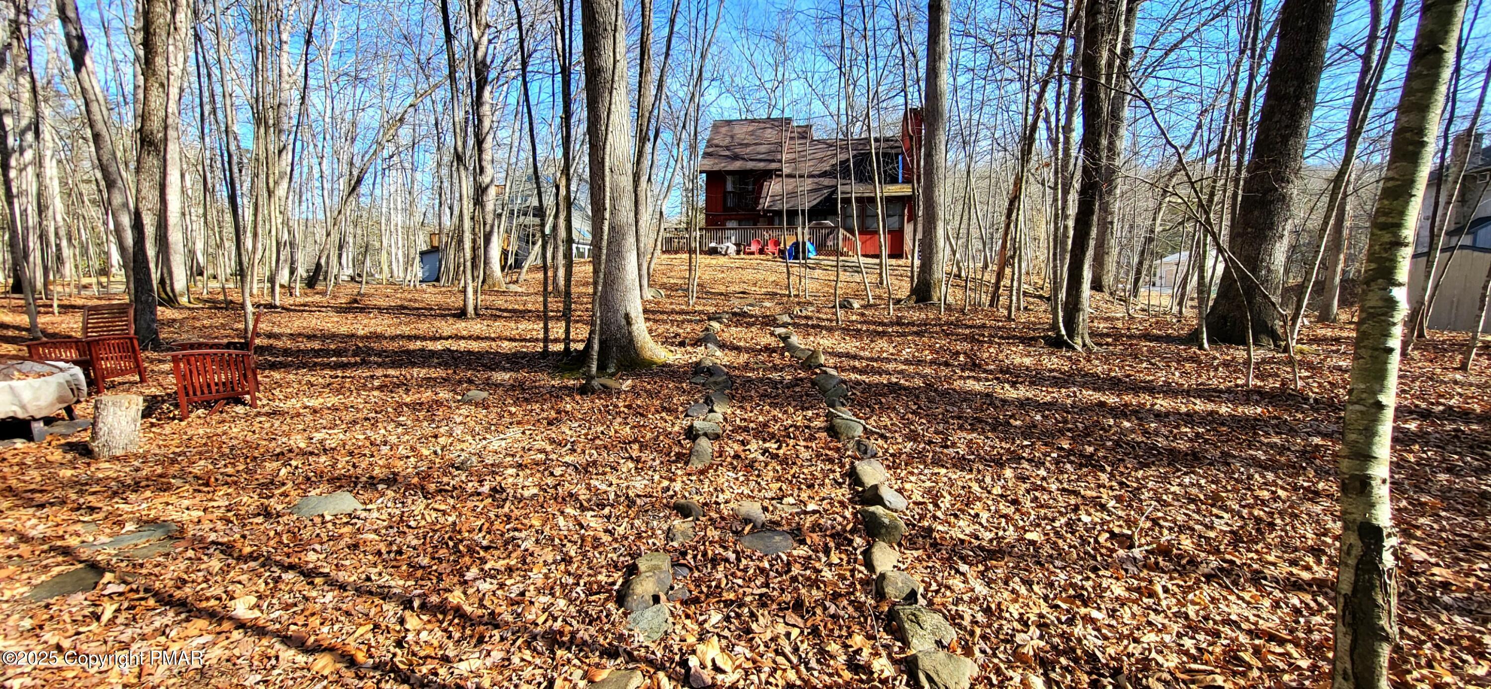 6298 Decker Road Bushkill, PA 18324 - Photo 8 of 65 a backyard of a house with barbeque oven table and chairs
