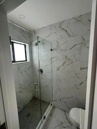 a bathroom with a toilet and a shower