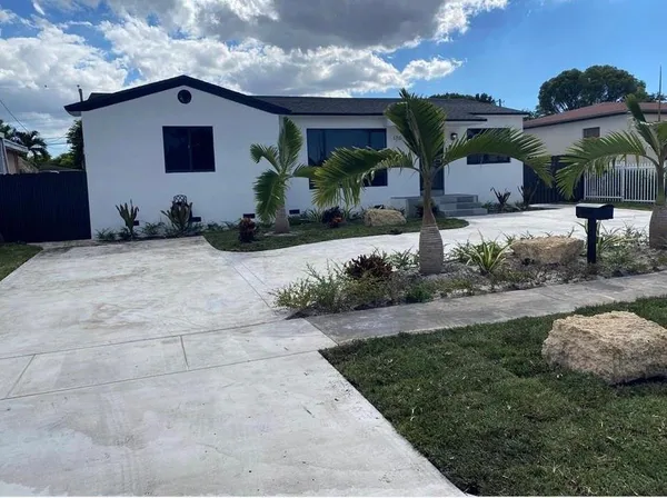 a front view of a house with garden