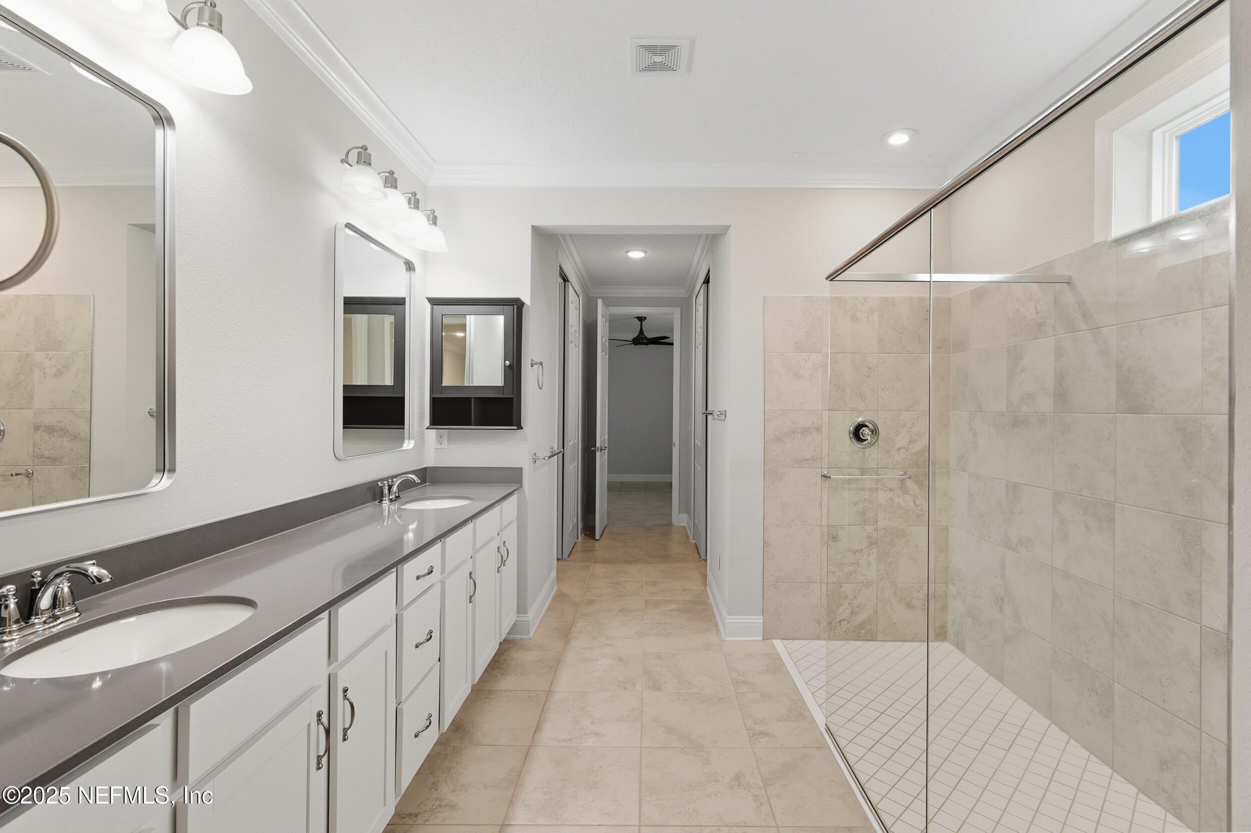 106 Key Grass Court St. Johns, FL 32259 - Photo 30 of 80 a bathroom with a double vanity sink and a mirror