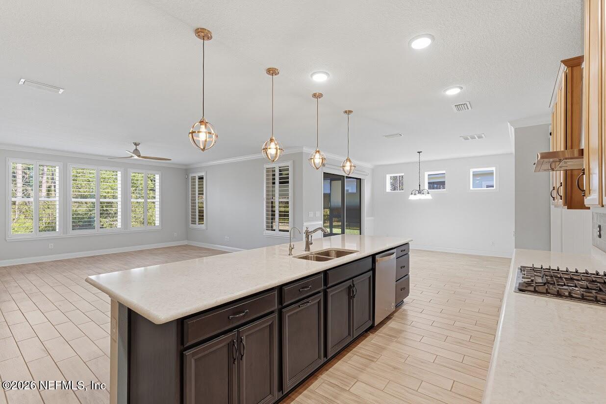 106 Key Grass Court St. Johns, FL 32259 - Photo 79 of 80 a kitchen with kitchen island granite countertop a sink and wooden floor