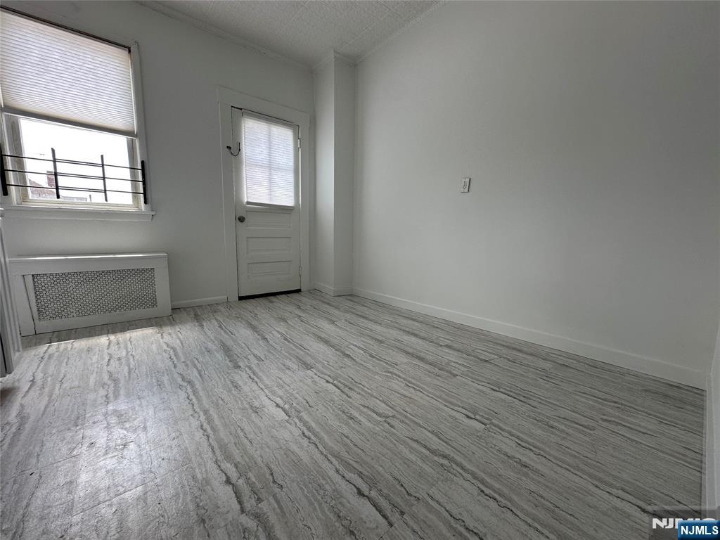 526 Valley Brook Avenue, Unit 2 Lyndhurst, NJ 07071 - Photo 3 of 13 an empty room with wooden floor and windows